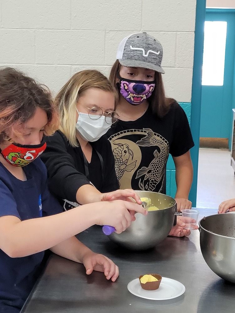 Students measuring and mixing in culinary class