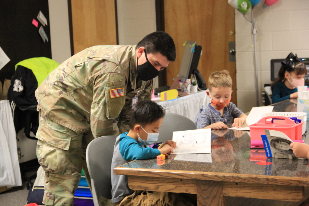 Army Specialist Mario Meraz lends a helping hand as a substitute teacher for Ana Bruner's  Kindergarten class